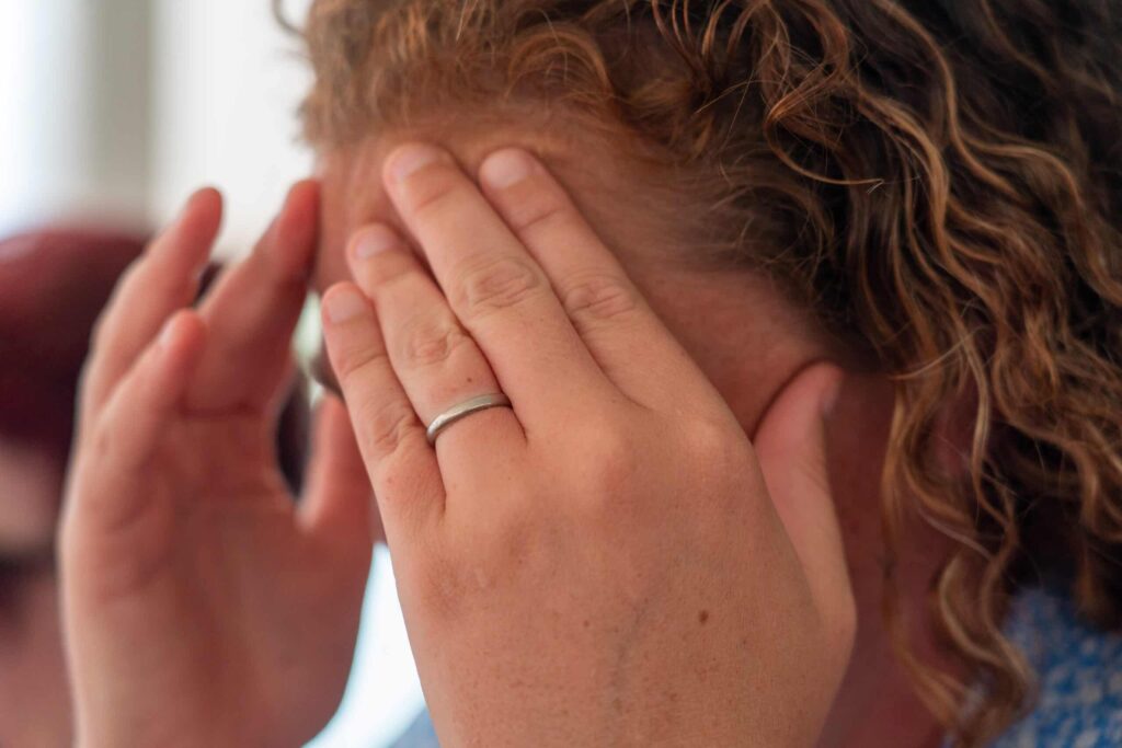 lady holding hands to head like she has a headache